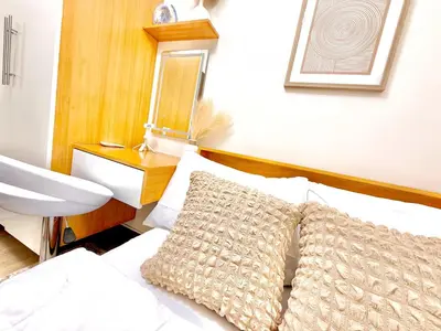 a bedroom with a bed with a sink and a pillow at Cozy and Comfy Retreat with Balcony in Manila
