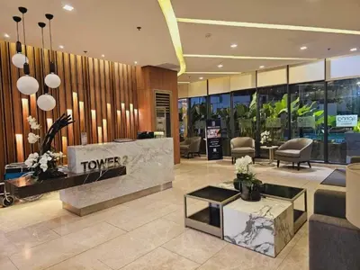 a lobby of a hotel with a table and chairs at Cozy and Comfy Retreat with Balcony in Manila