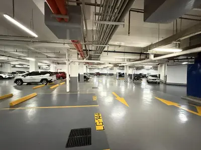 an empty parking garage with cars parked in it at Cozy and Comfy Retreat with Balcony in Manila