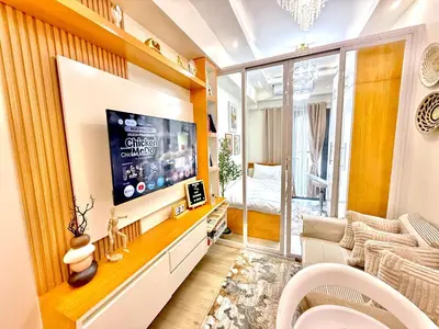 a living room with a tv and a couch at Cozy and Comfy Retreat with Balcony in Manila