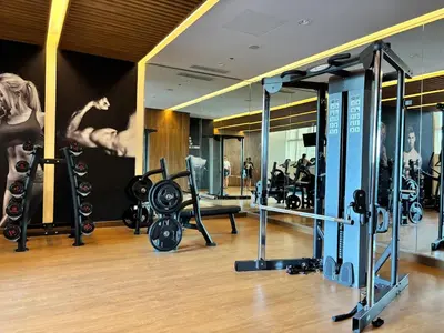 a gym with several treadmills and machines at 10L Luxe City Escape at Park Mckinley West in Manila