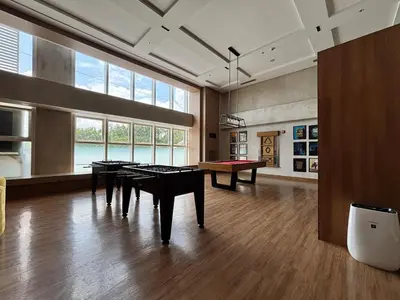 a large room with tables and a pool table at 10L Luxe City Escape at Park Mckinley West in Manila