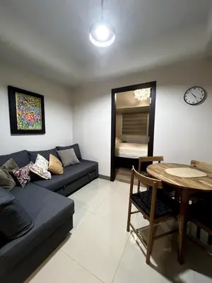 a living room with a couch and a table at 10L Luxe City Escape at Park Mckinley West in Manila