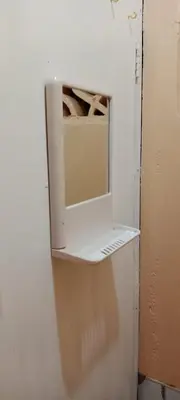 a microwave sitting on top of a shelf in a room at Bunkaroo in Manila