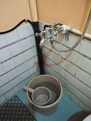 a dirty bathroom with a toilet in a room at Bunkaroo in Manila