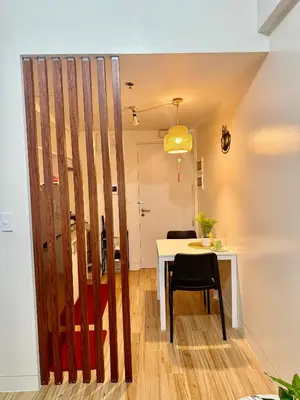 a dining room with a table and a chair at J&A Cozy Calm Stay in Biñan