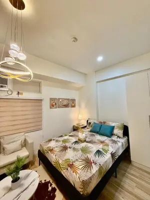 a bedroom with a large bed in a room at J&A Cozy Calm Stay in Biñan