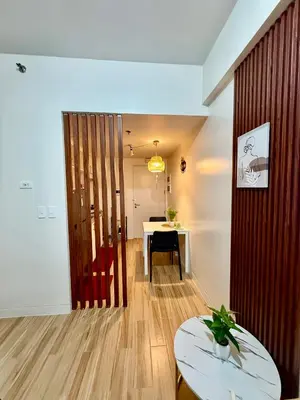 a living room with a table and a dining room at J&A Cozy Calm Stay in Biñan