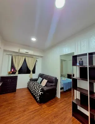 a living room with a couch and a bed at 1BR Retro-styled Condo unit in BGC, Taguig City in Manila