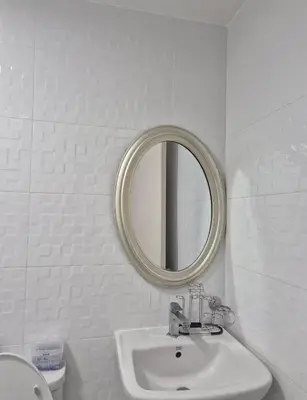 a white bathroom with a sink and a mirror at 1BR Retro-styled Condo unit in BGC, Taguig City in Manila