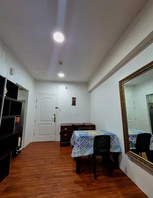 a room with a table with a mirror and a mirror at 1BR Retro-styled Condo unit in BGC, Taguig City in Manila