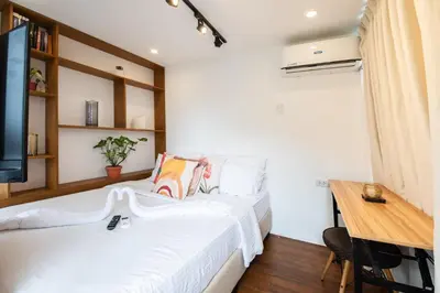 a bedroom with a bed and a desk and a television at Container Home Mandaluyong N01 in Manila