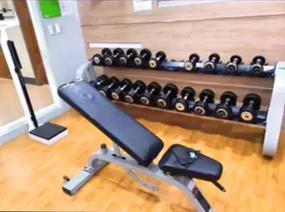 a gym with a rack of dumbbells at Cozy Modern Studio Two Palm Tree Villas in Manila