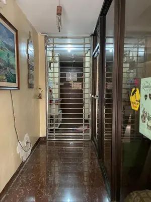 a hallway with a glass door leading to a elevator at Studio Type Manila in Manila
