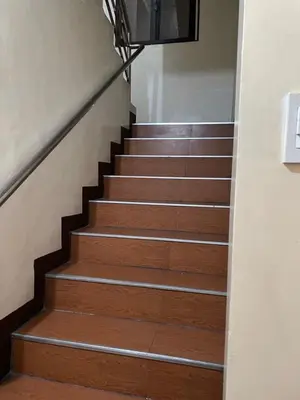 a stairway with wooden steps and a railing at Studio Type Manila in Manila