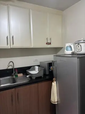 a kitchen with a sink and a refrigerator at Family Suite-150Newport Boulevard Southwing in Manila