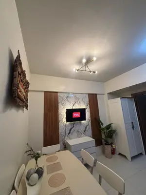 a dining room with a table and a tv on the wall at Family Suite-150Newport Boulevard Southwing in Manila