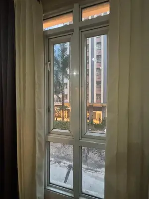 a window with a view of a city at Family Suite-150Newport Boulevard Southwing in Manila