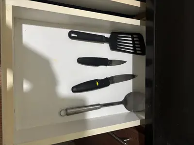 a drawer filled with utensils in a cabinet at Family Suite-150Newport Boulevard Southwing in Manila