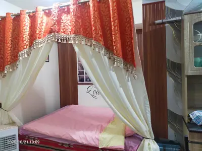 a bed in a room with curtains at JC Palace Residence in Manila