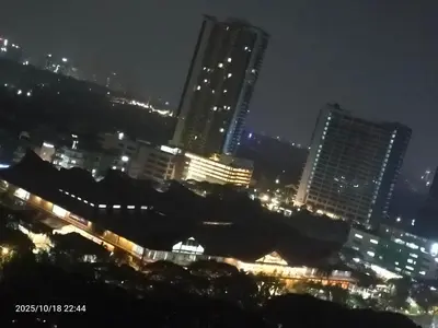 a city skyline at night with tall buildings at JC Palace Residence in Manila