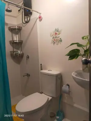 a bathroom with a toilet and a sink at JC Palace Residence in Manila