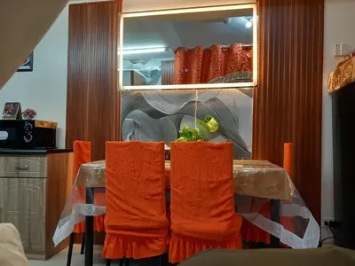 a kitchen with a table with orange towels on it at JC Palace Residence in Manila