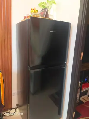a large black refrigerator in a room at JC Palace Residence in Manila