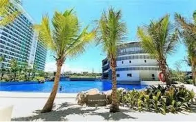 a group of palm trees in front of a building at Azure Urban Resort Residence A51 in Manila