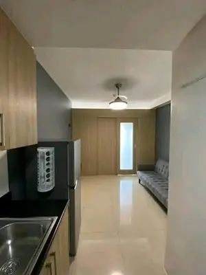 a kitchen with a couch in the middle of a room at Vacation at HM Place in Manila