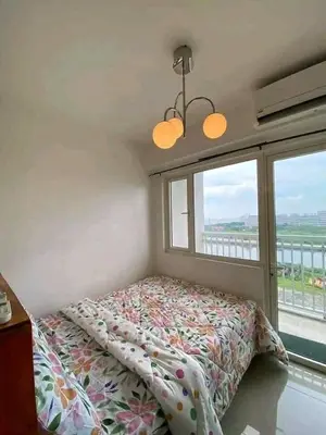 a bedroom with a bed in front of a window at Vacation at HM Place in Manila