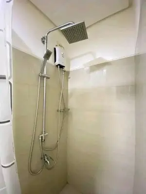a shower stall in a bathroom with a shower head at Vacation at HM Place in Manila