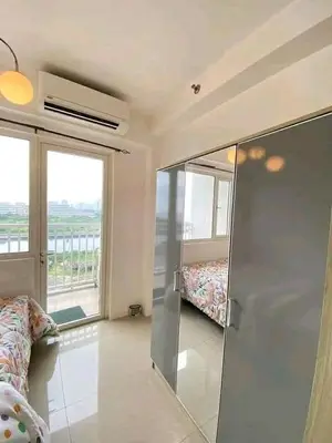 a room with a glass door with a bed and a window at Vacation at HM Place in Manila