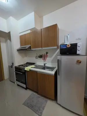 a kitchen with a sink and a refrigerator at 8 Adriatico Condominium in Manila