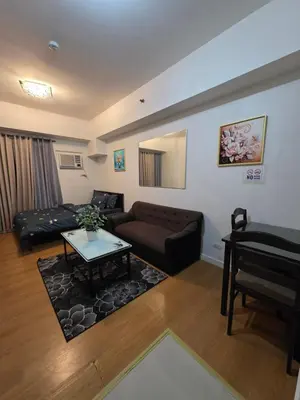 a living room with a couch and a table at 8 Adriatico Condominium in Manila