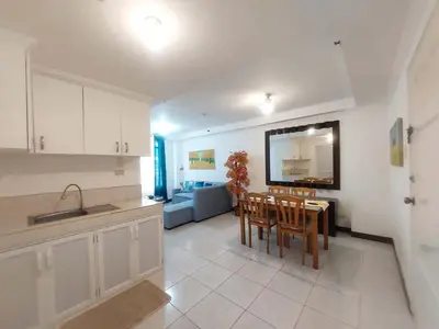 a kitchen and dining room with a table and chairs at Condotels by Mandolin Suite in Manila