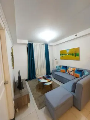 a living room with a couch and a table at Condotels by Mandolin Suite in Manila