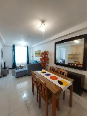 a living room with a table and a couch at Condotels by Mandolin Suite in Manila
