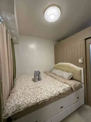 a bedroom with a bed with shoes on it at shore residences admin in Manila