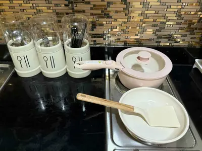 a counter top with some utensils and a bowl and a measuring at shore residences admin in Manila