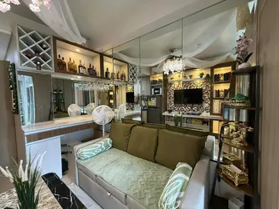 a living room with a couch and a large mirror at shore residences admin in Manila
