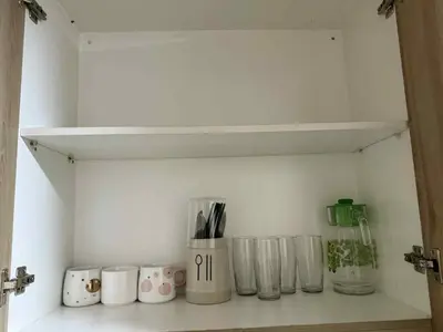 a shelf with cups and utensils on a wall at shore residences admin in Manila
