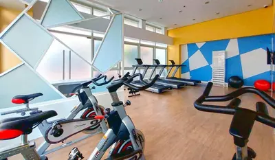 a gym with several exercise bikes in a room at J&A Cozy Calm Stay in Biñan