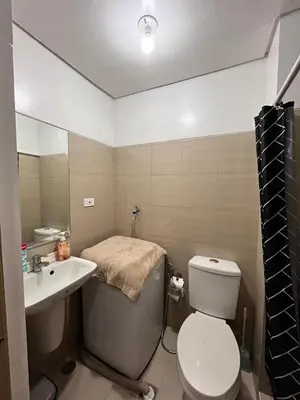 a small bathroom with a toilet and a sink at Apartment in Pasay at Shore Residences in Manila