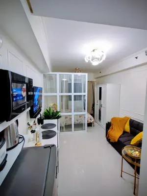 a living room with a couch and a table at ASV Condo Staycation SMDC Breeze in Manila
