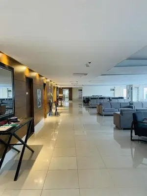 a large lobby with couches and tables in a building at ASV Condo Staycation SMDC Breeze in Manila