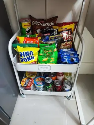 a cart full of food and snacks in a refrigerator at ASV Condo Staycation SMDC Breeze in Manila