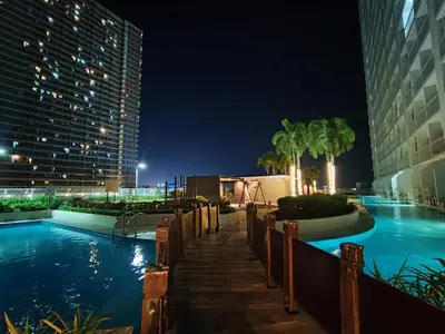 a swimming pool in a hotel at night at ASV Condo Staycation SMDC Breeze in Manila