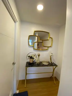 a room with a table with a mirror on the wall at LSB Modern Penthouse in Manila