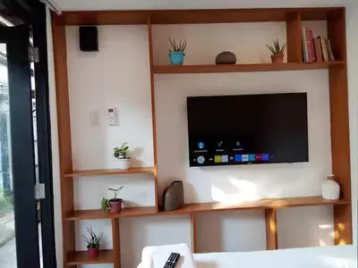 a living room with a flat screen tv on a wall at Container Home Mandaluyong N04 in Manila